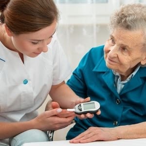 30095131 - female nurse measuring blood glucose level of senior woman
